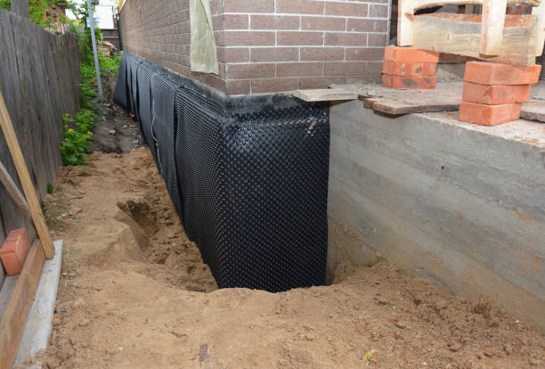 Happy homeowners after waterproofing job in Malone